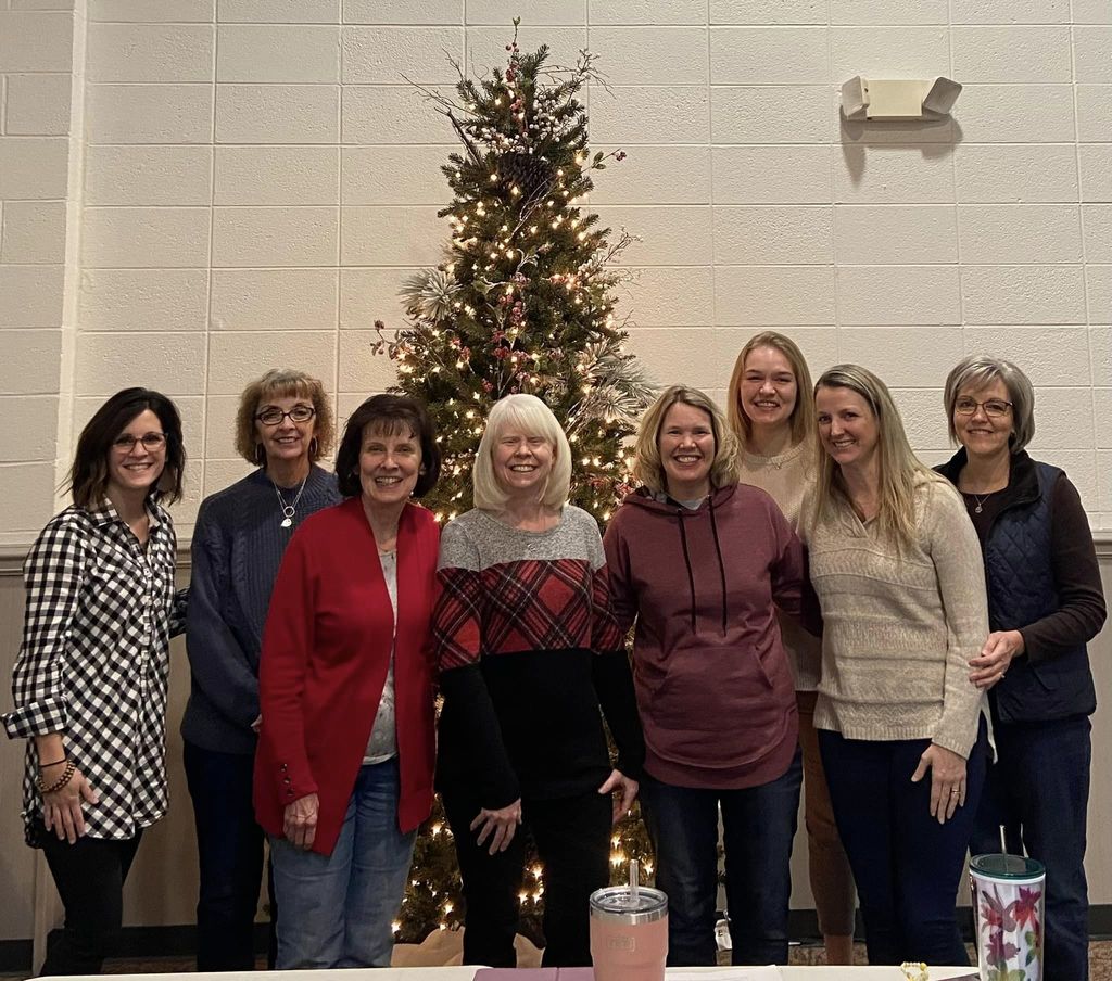 Crosspointe Indy Ladies Ministries standing in front of a christmas tree